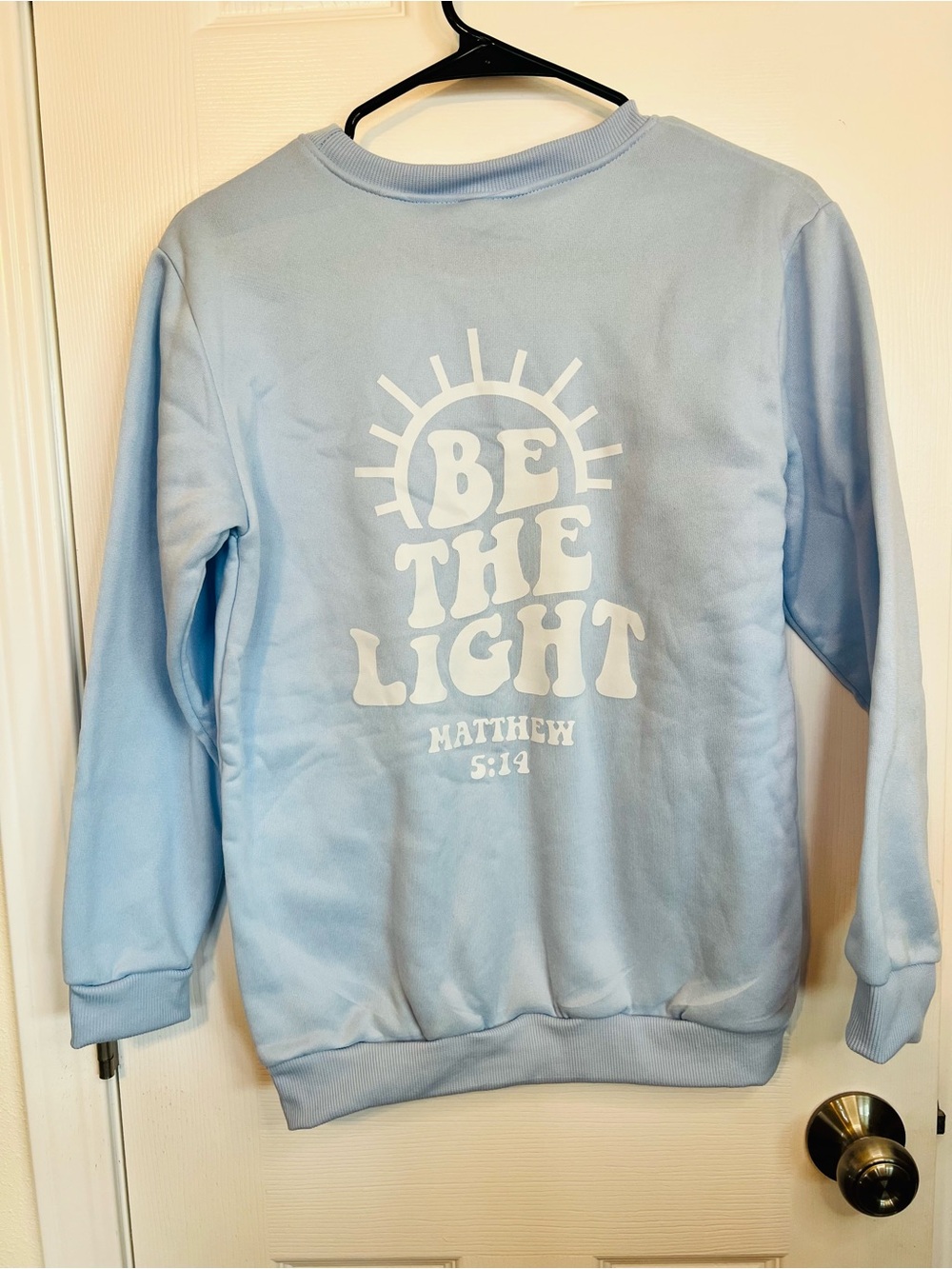 “Be the Light” 💡 Women's Light Blue Crewneck Sweater - Classic Everyday Pullover